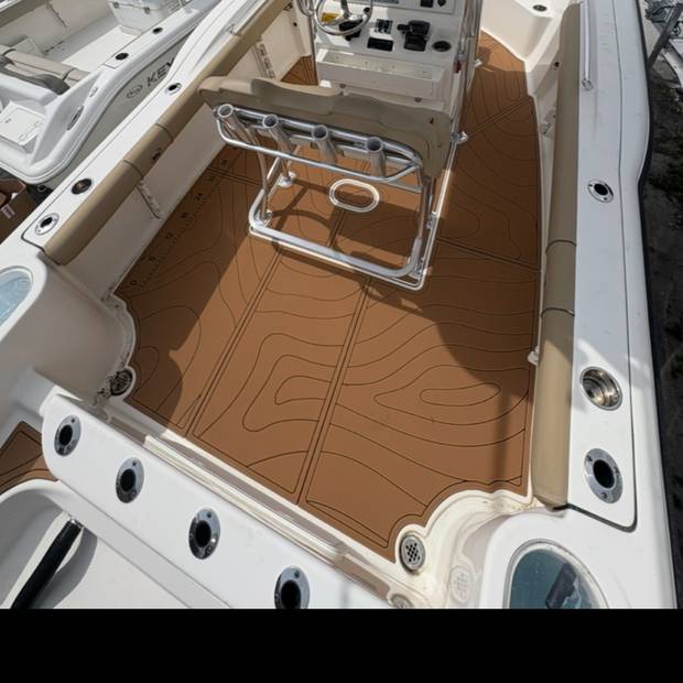 Cockpit sole on a centre console, brown decking with a topographic pattern