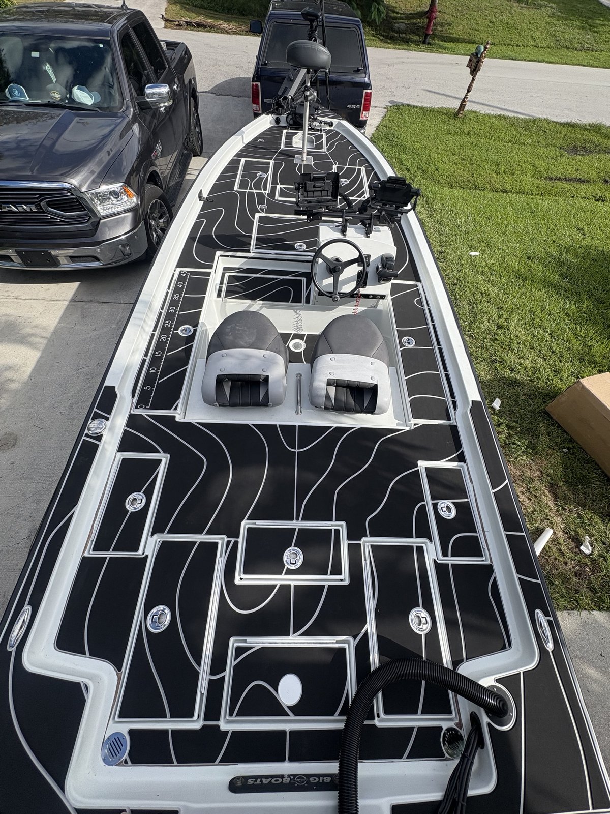 Full deck on a Big O Boats skiff, black planking with a white topographic pattern