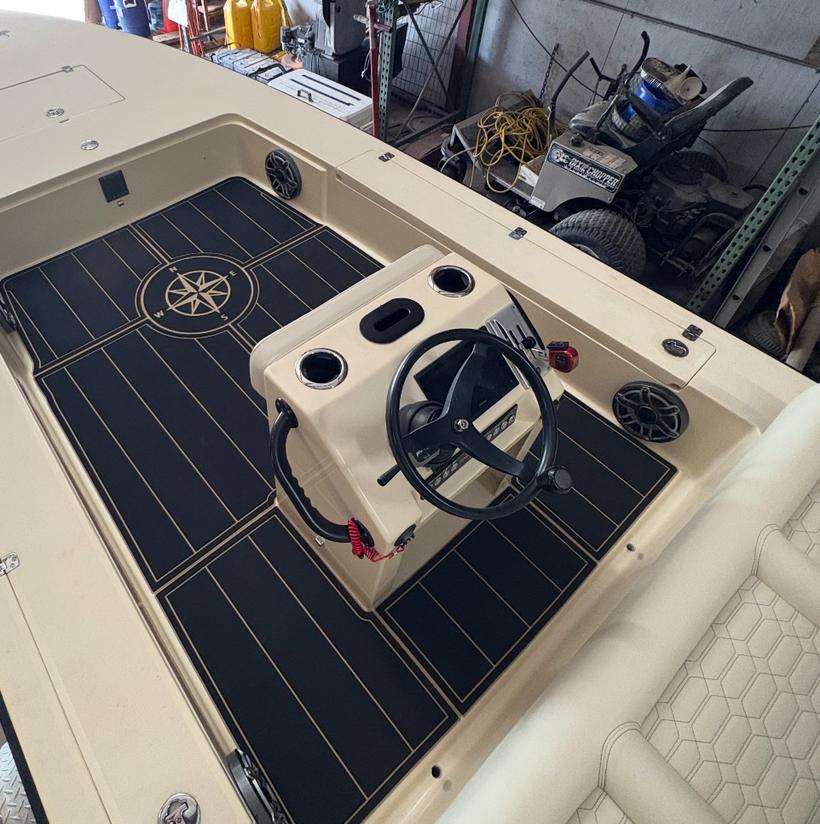 Skiff deck after: black planking with tan seams and an inlaid compass rose