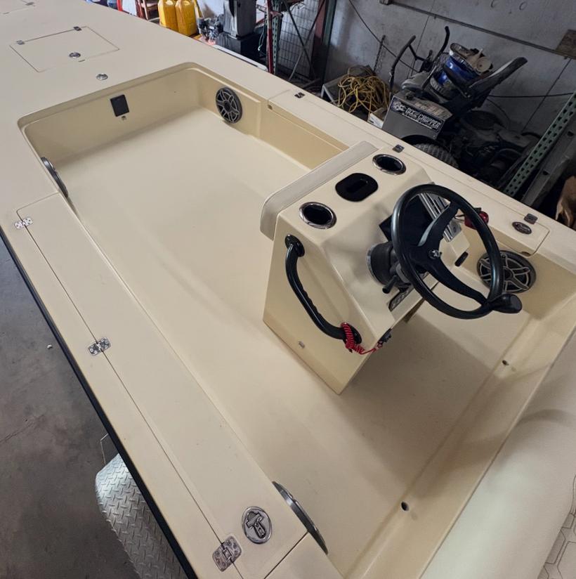 The same skiff before: bare tan gelcoat deck